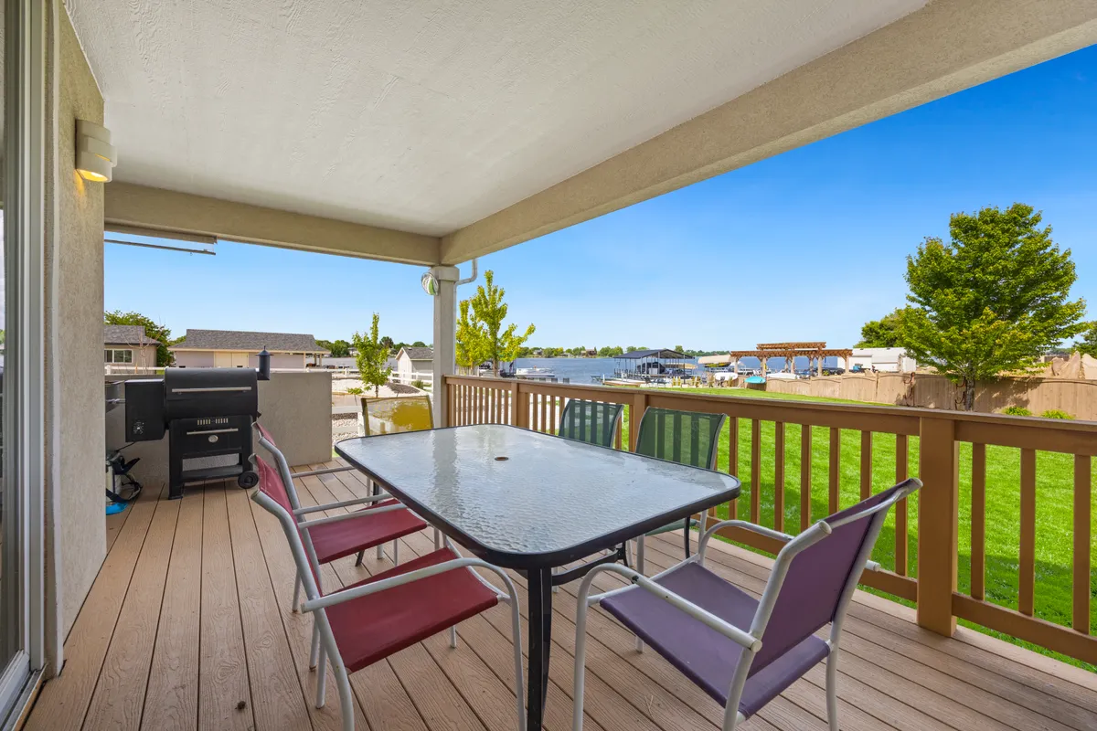 Composite deck patio with outdoor seating overlooking a lake, Millard