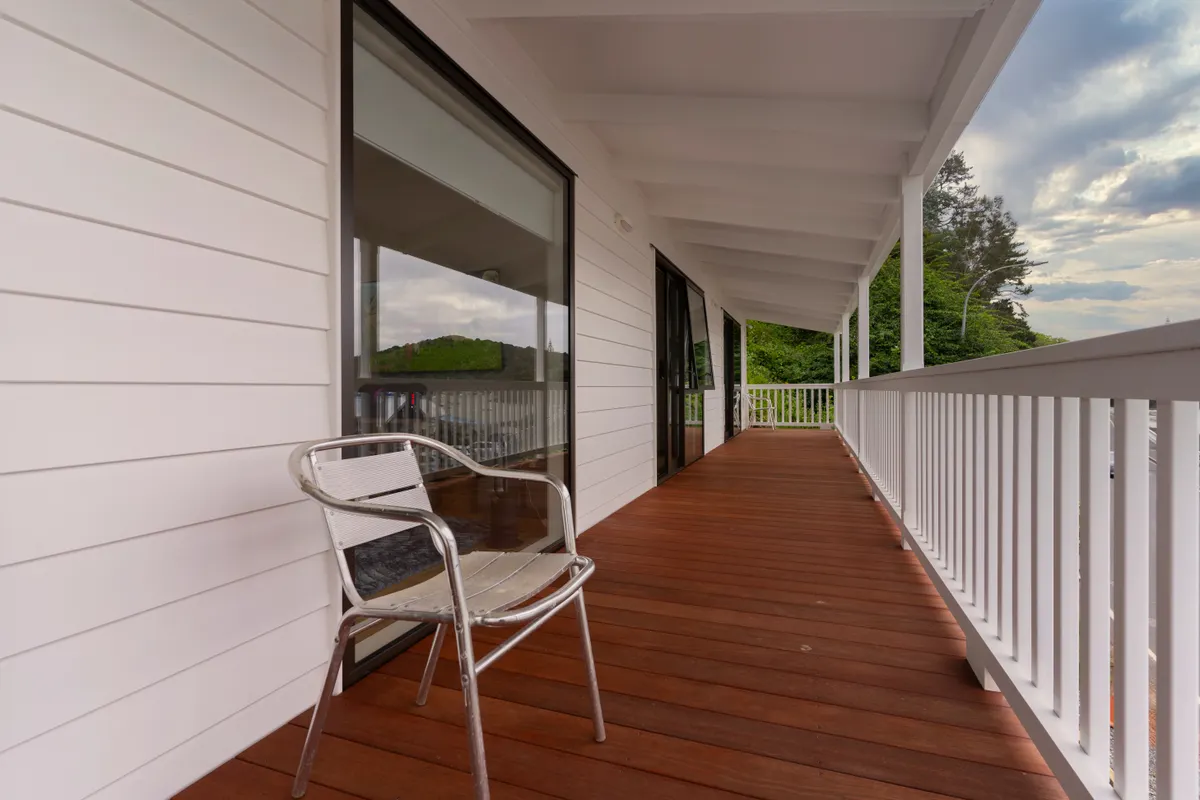 Contemporary wooden porch deck with metal chair and custom design, Papillion