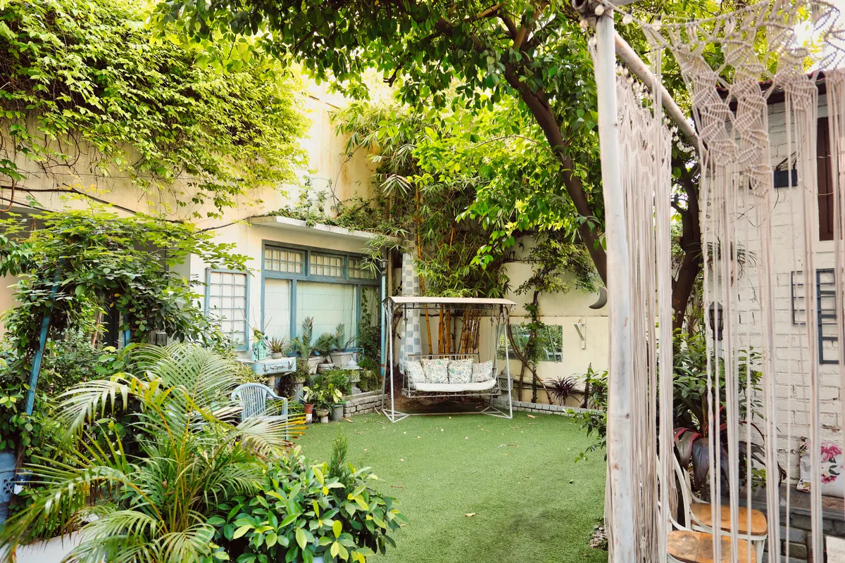 Lush backyard garden with a swing and freshly stained deck seating, Elkhorn