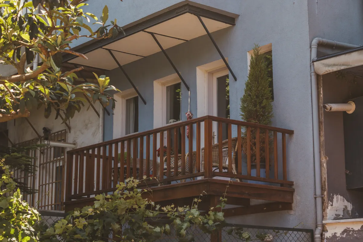 Small balcony with repaired wooden railing and plants, Douglas County