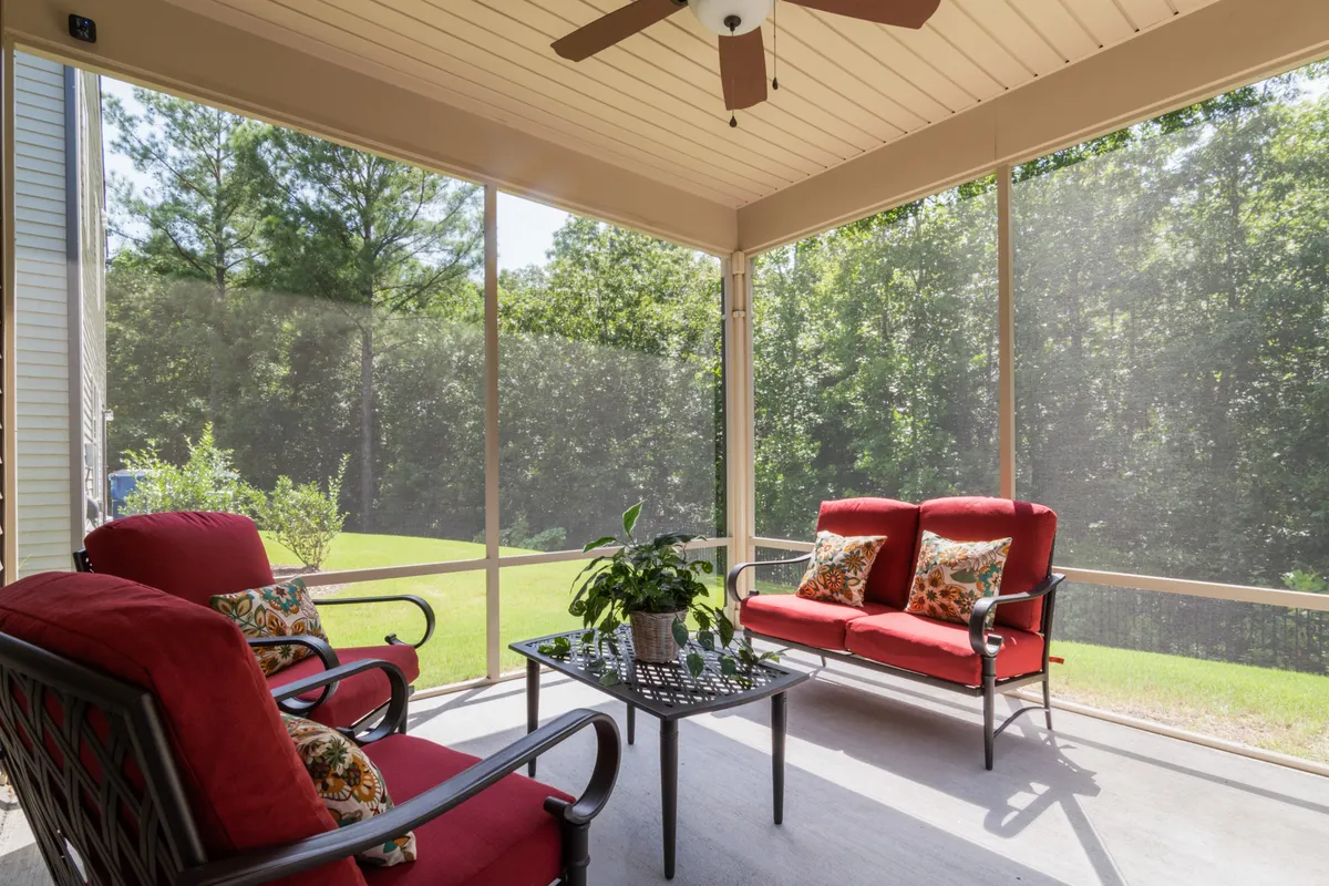 Modern composite patio deck with red cushioned seating and garden view, west Omaha